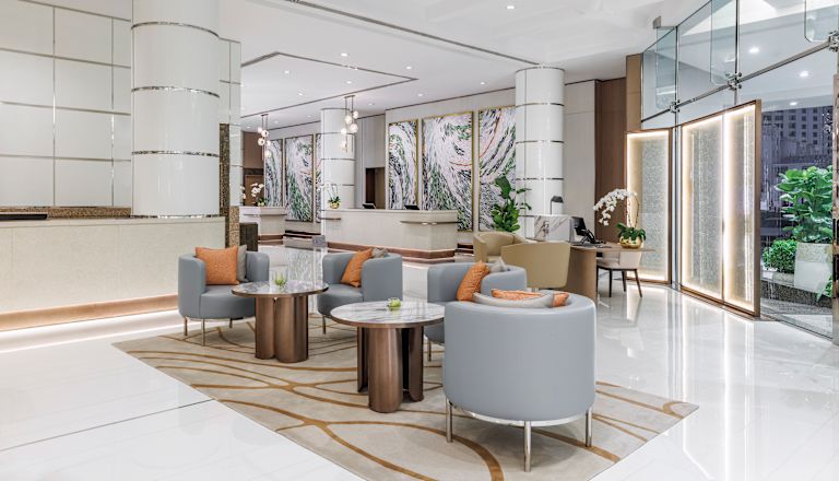 Lobby area with comfortable seating, tables and plants