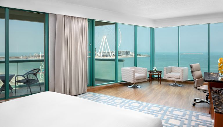 Sea View from Suite with Large Bed Balcony Work Desk and Seating Area