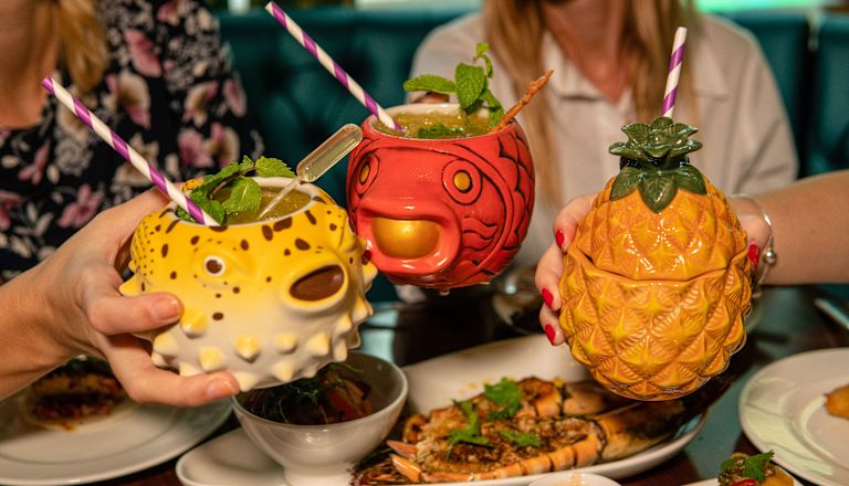 Selection of cocktails in seafood themed mugs