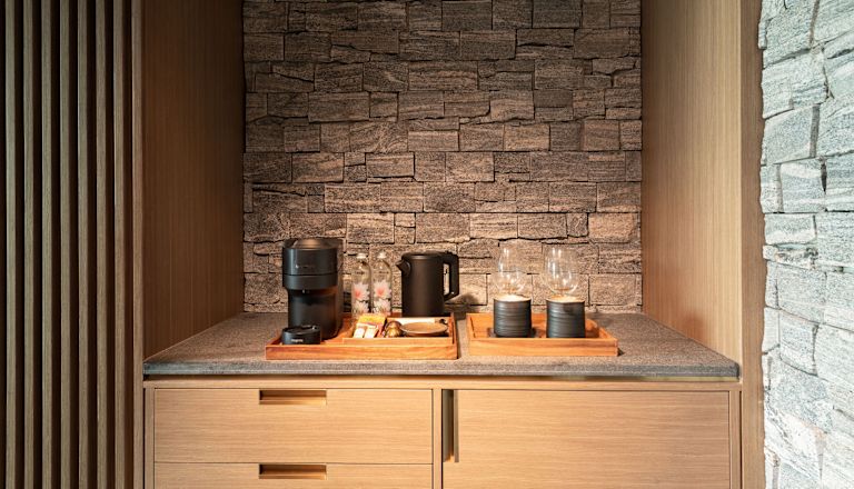 Coffeemaker and Water Amenities in a Suite