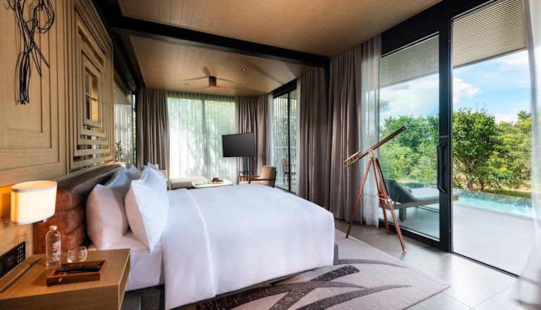 Large bed in a suite with pool