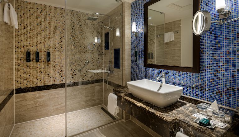 Guestroom bathroom with shower and vanity area