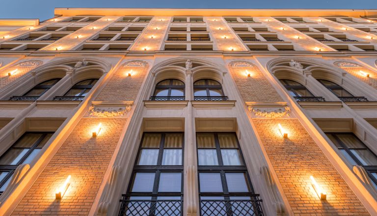 Hotel exterior from the ground, with view of windows and lighting