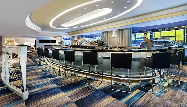Bridges Bar in Oval Setting with Black Chairs