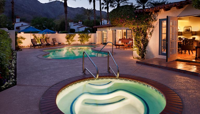 El Presidente Suite outdoor pool and hot tub in the evening with mountains in the background