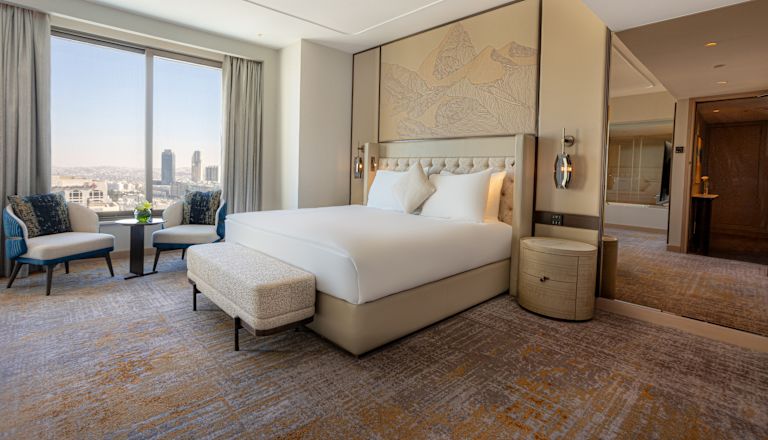 King Club Signia Ambassador Suite Bedroom with Lounge Chair