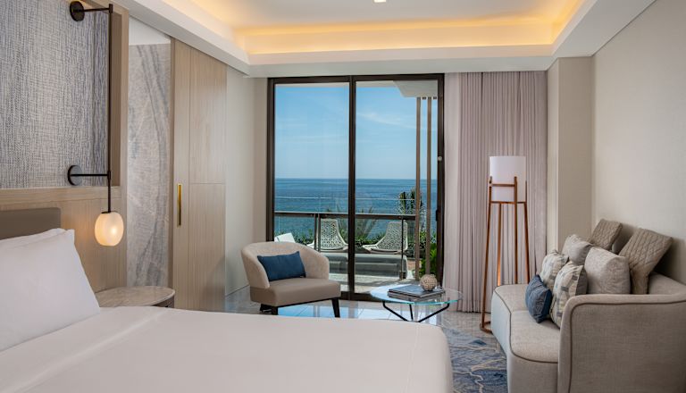 Presidential suite bedroom with sofa and chair