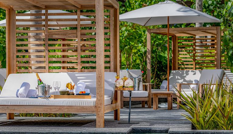 Poolside seating with snacks and drinks