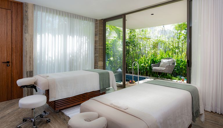 spa treatment room with two beds