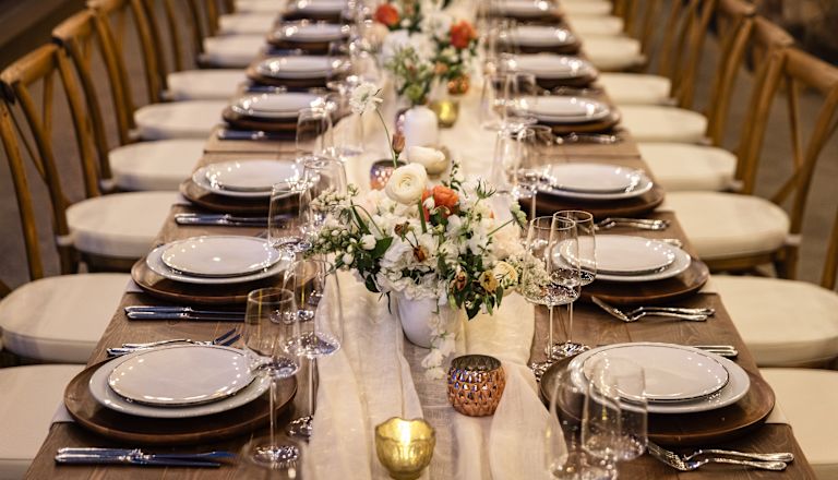 A Large Table Setup  with Flowers for Dining on an Special Event