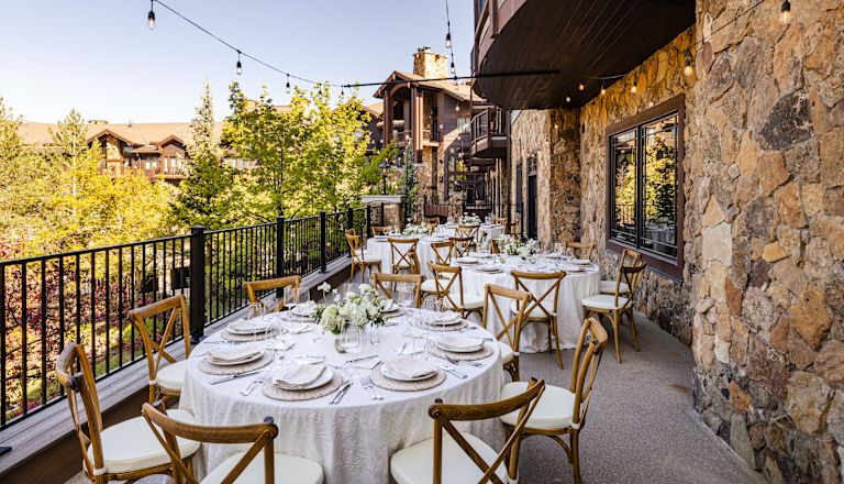 Frostwood Terrace, round reception tables with white tablecloths and dinner ware