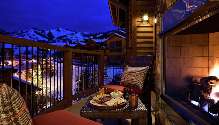 Balcony area with seating and fireplace