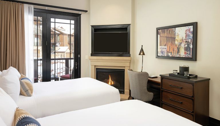 2 beds in room with TV