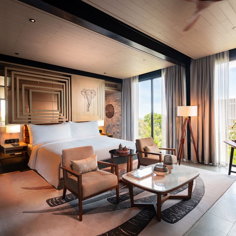 Large Bed in a Room with Sitting Area and a Large Window