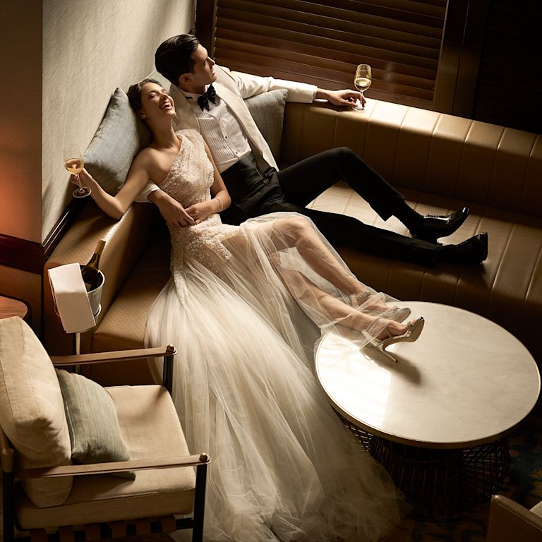 Couple Drinking and Relaxing on Their Wedding Day
