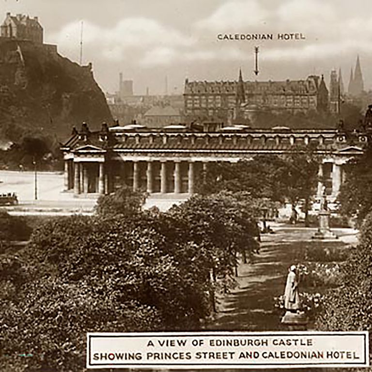 Old shot of arrow pointing to Caledonian hotel with Edinburgh surrounding