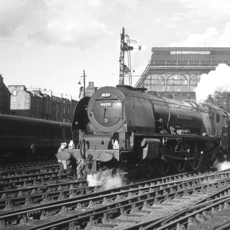 Old shot of train pulling out of station