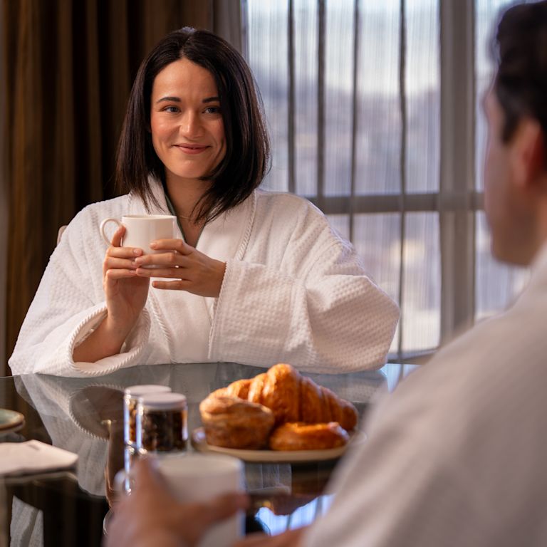 Couple having breakfast in a guest room