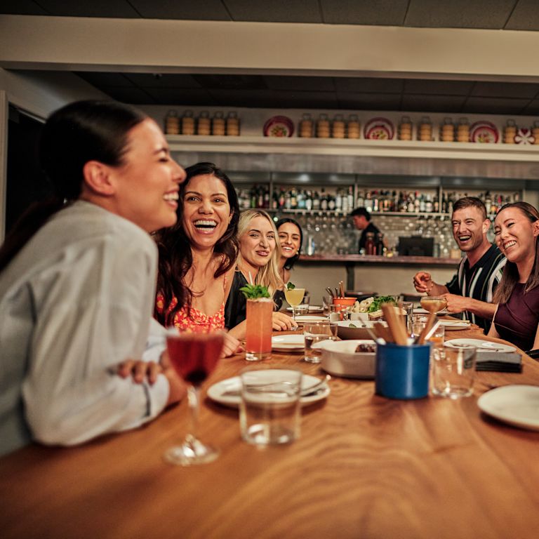 A group of people is dining at Kin Khao restaurant