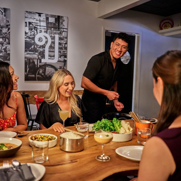 Server is talking to guests at Kin Khao restaurant
