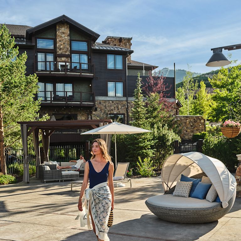 Woman Walking in Outdoor Pool Area