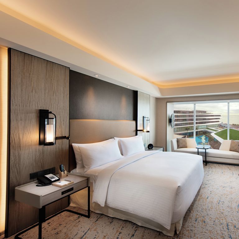 Deluxe Guestroom with Bed, Room Technology, Lounge Area, Work Desk, and Outside View