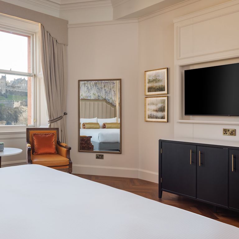 1 queen bed guest room with window view of the castle