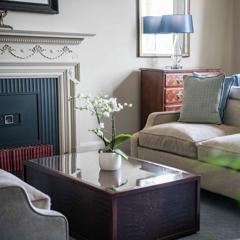 Couch in room with table and mirror