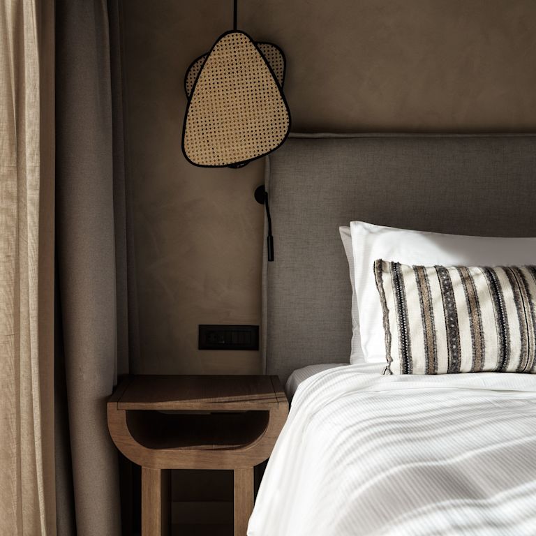 Large Bed and Nightstand in a Room