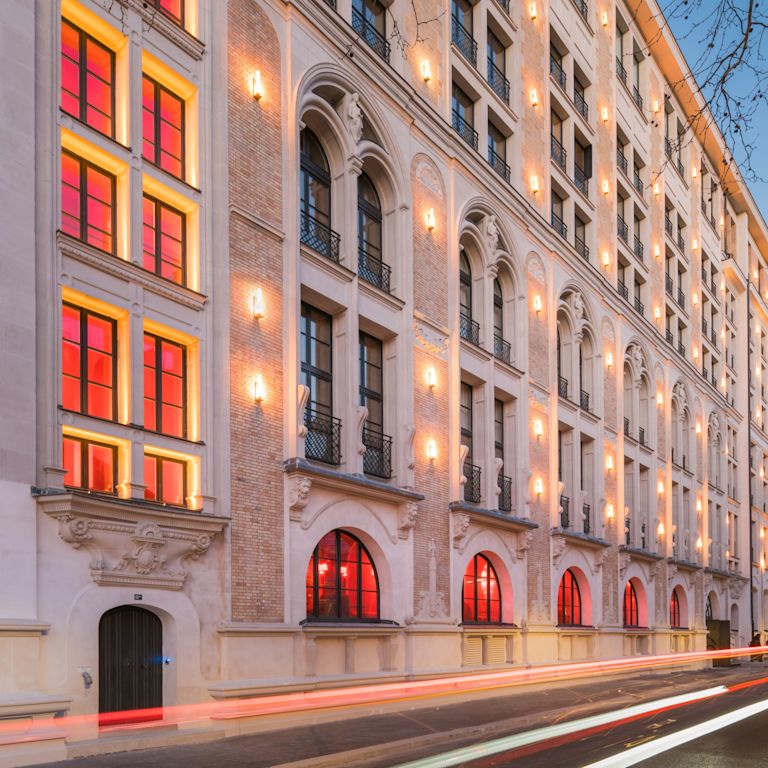 Hotel exterior with windows, lighting and entrance