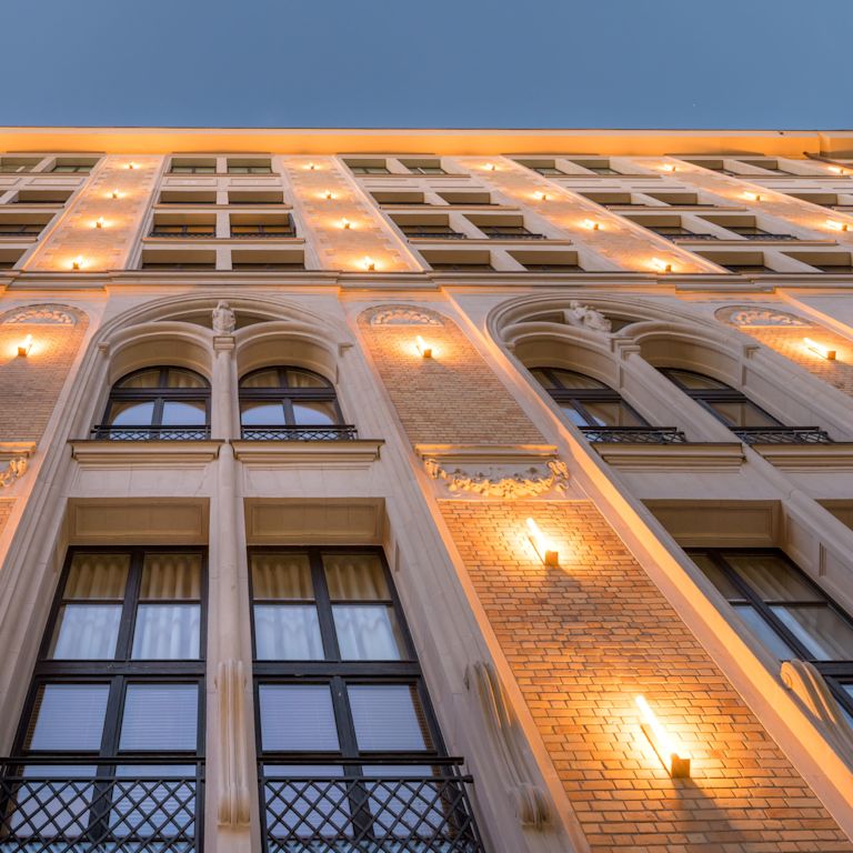 Hotel exterior from the ground, with view of windows and lighting