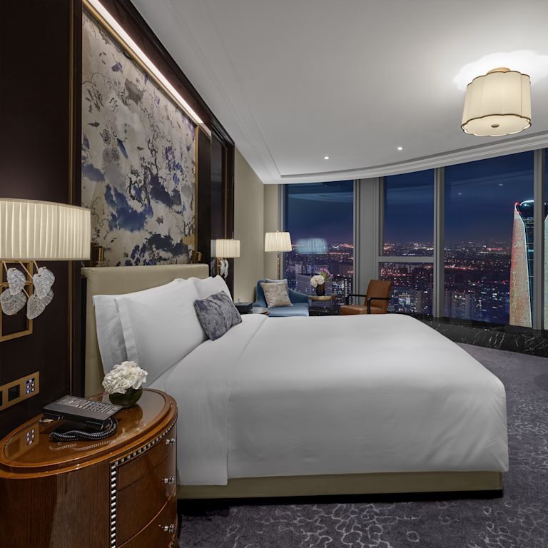 guest room, 1 king bed, work desk, window view of the city at night