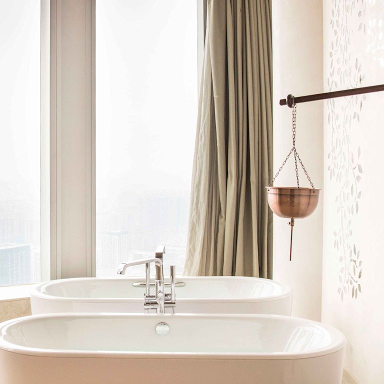 Bathtub next to large windows at the spa