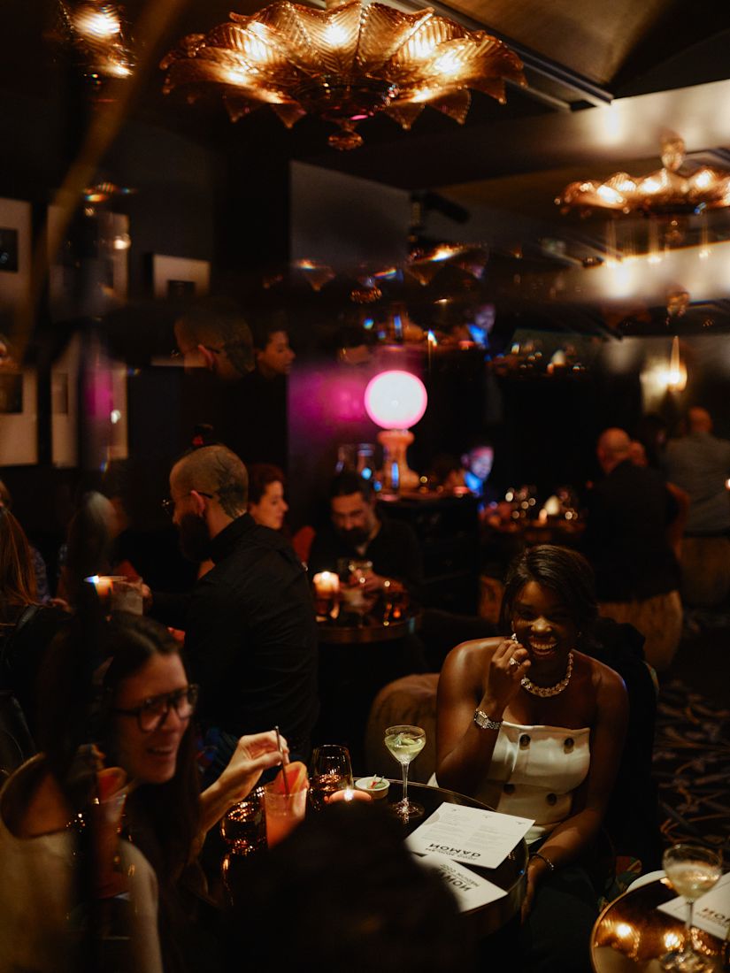 holiday party, guests sitting at a table having cocktails-previous-transition
