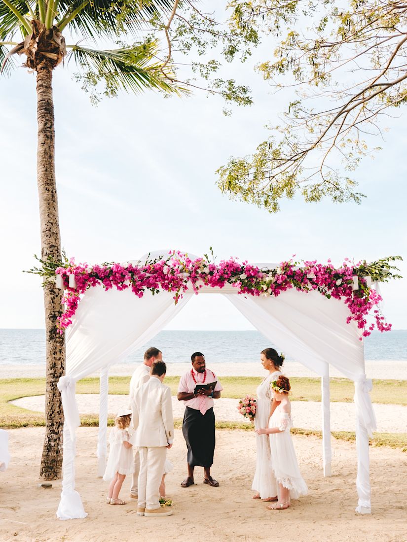 Outdoor wedding under flower canopy-transition