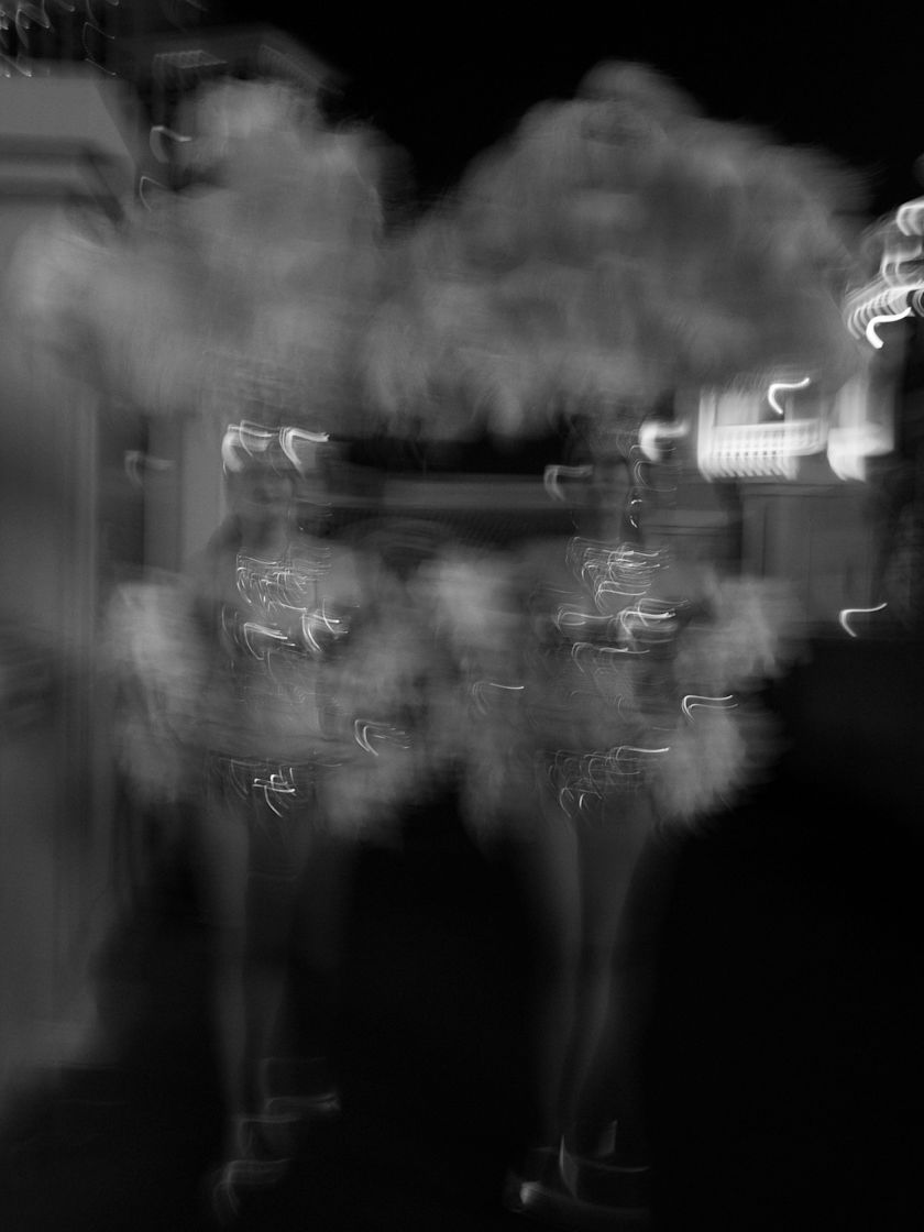 Blurred nighttime scene with bright light trails against a dark background-previous-transition