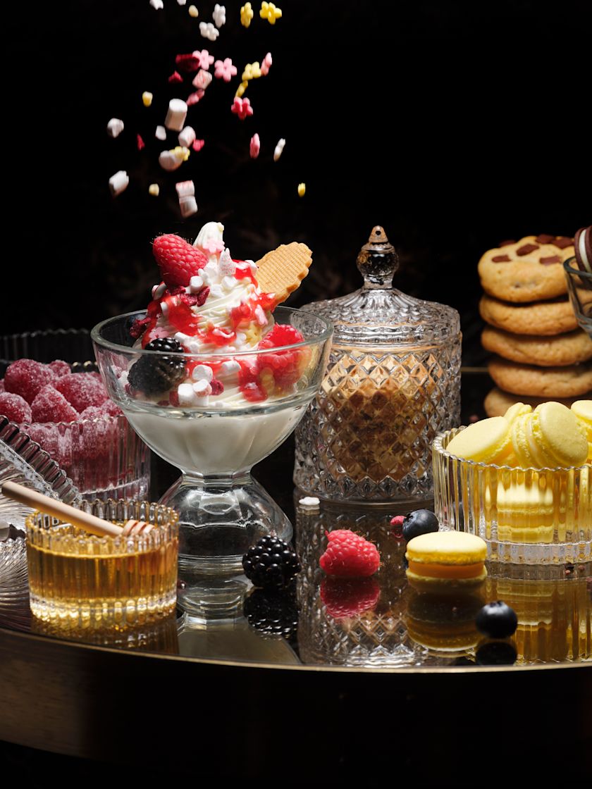 Twenty8 NoMad - Selection of desserts on a glass tray with sprinkles falling from above-next-transition