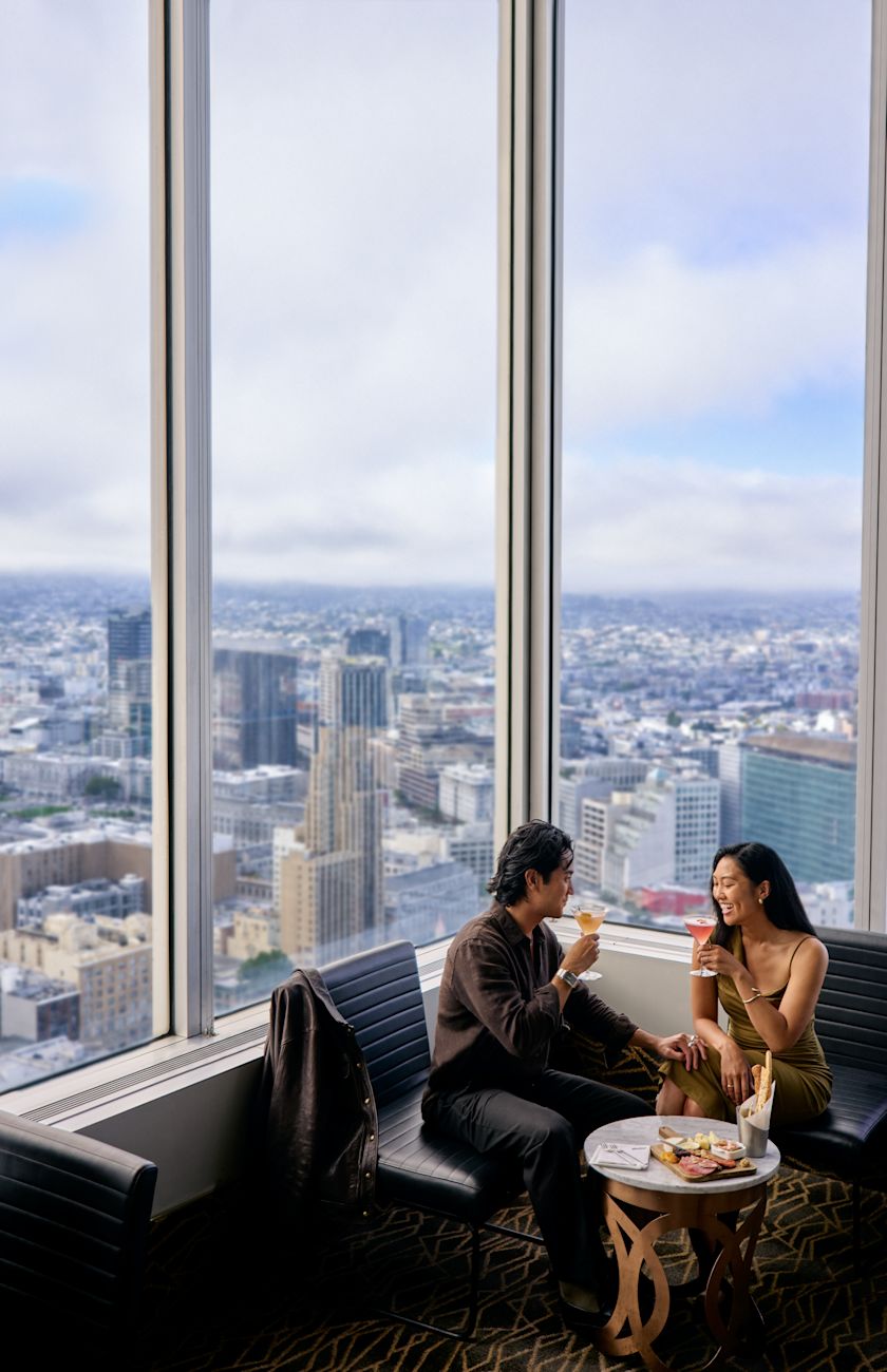 Couple dining at Cityscape Sky Bar Waiter serving drinks to a couple dining at Cityscape Sky Bar  with Panoramic Views of the City