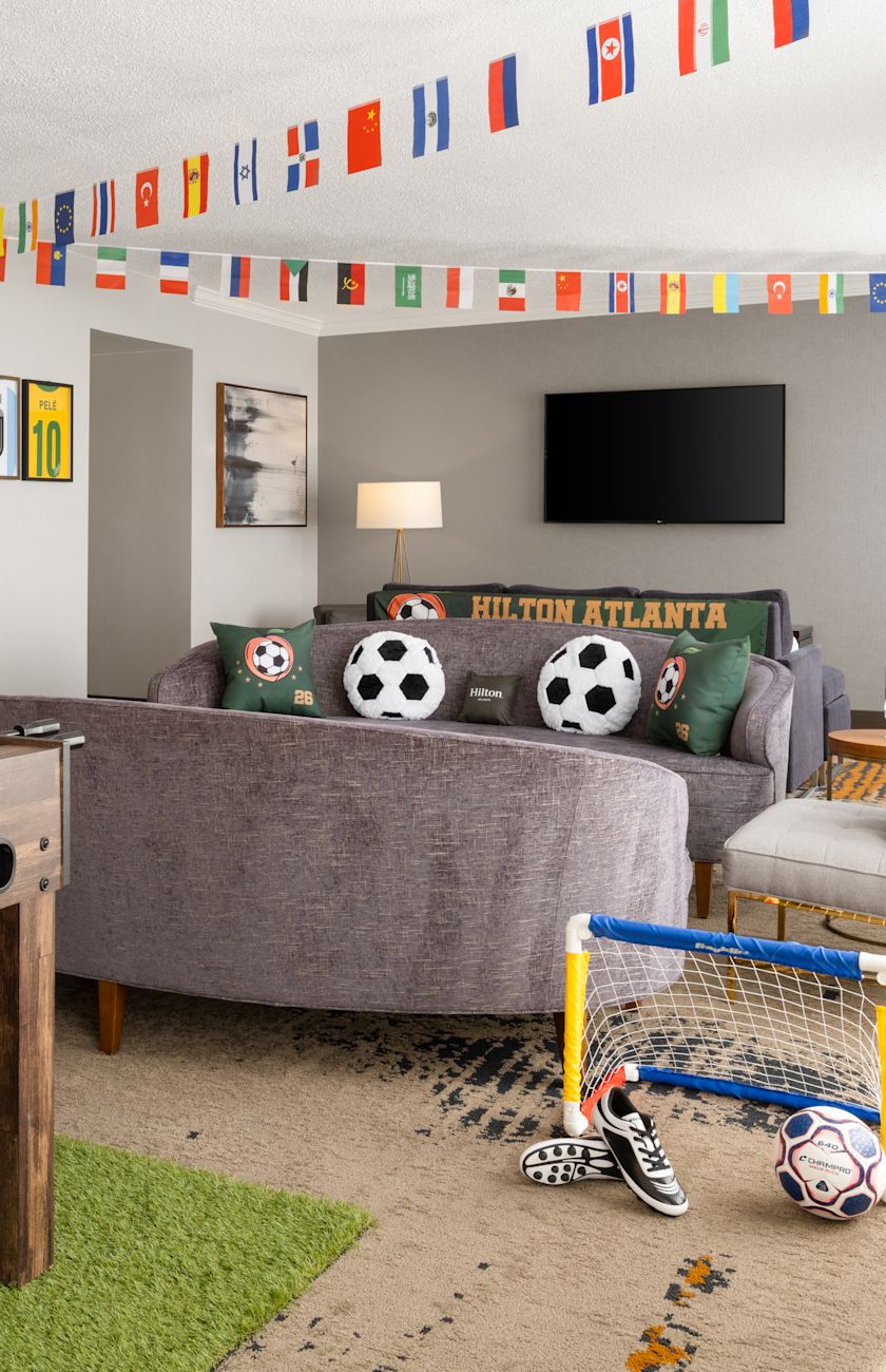 Foosball Table in a Living Room of a Soccer Theme Suite