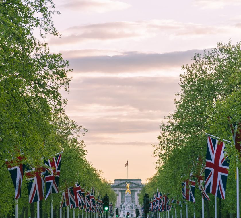 Outdoor sunset with British flags lining the street.