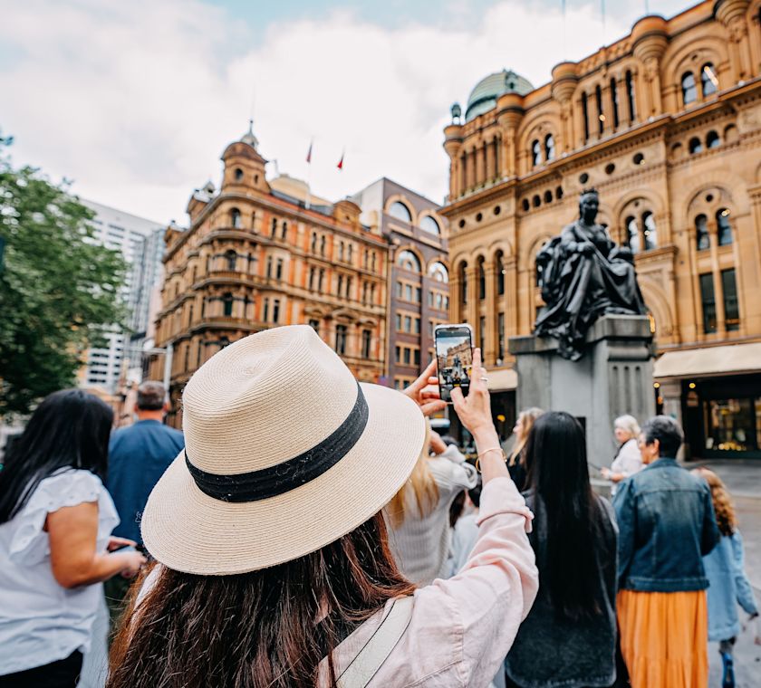 Person in a hat standing outside of the hotel