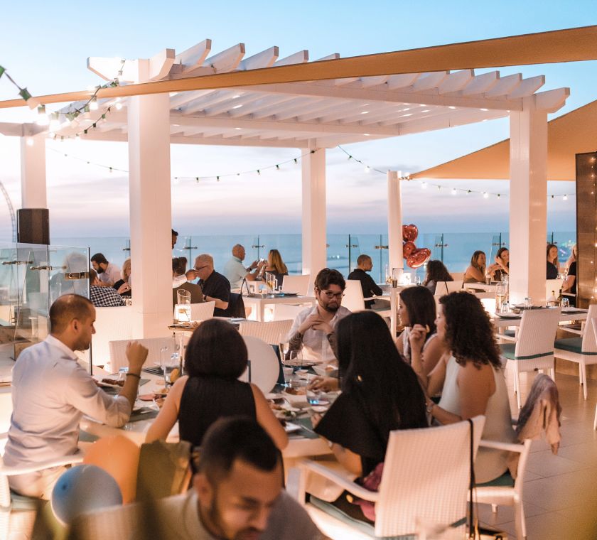 People dining on the terrace of Pure Sky Lounge
