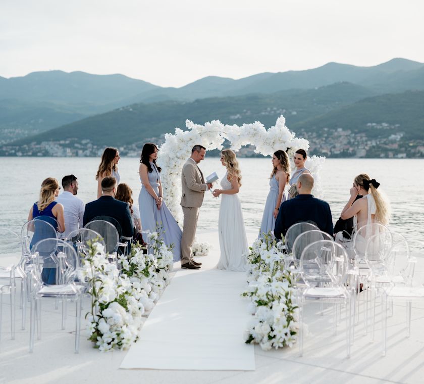 Wedding Celebration at the Beach with Water and Mountains in Background