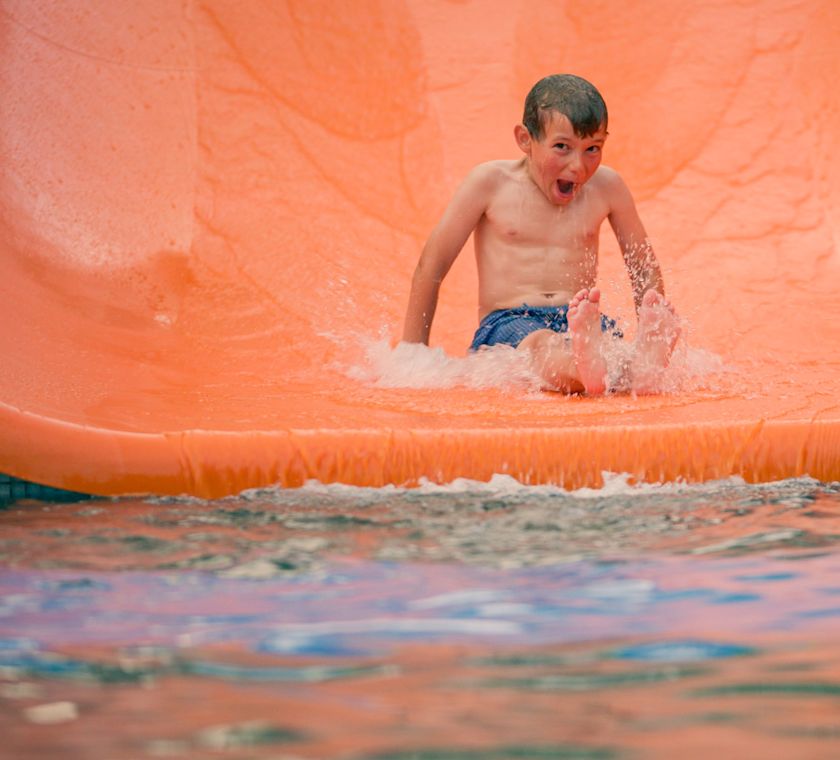 Kid sliding on water slide