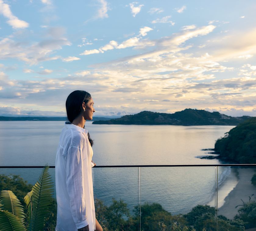 Woman Enjoying the View from a Balcony in a Suite