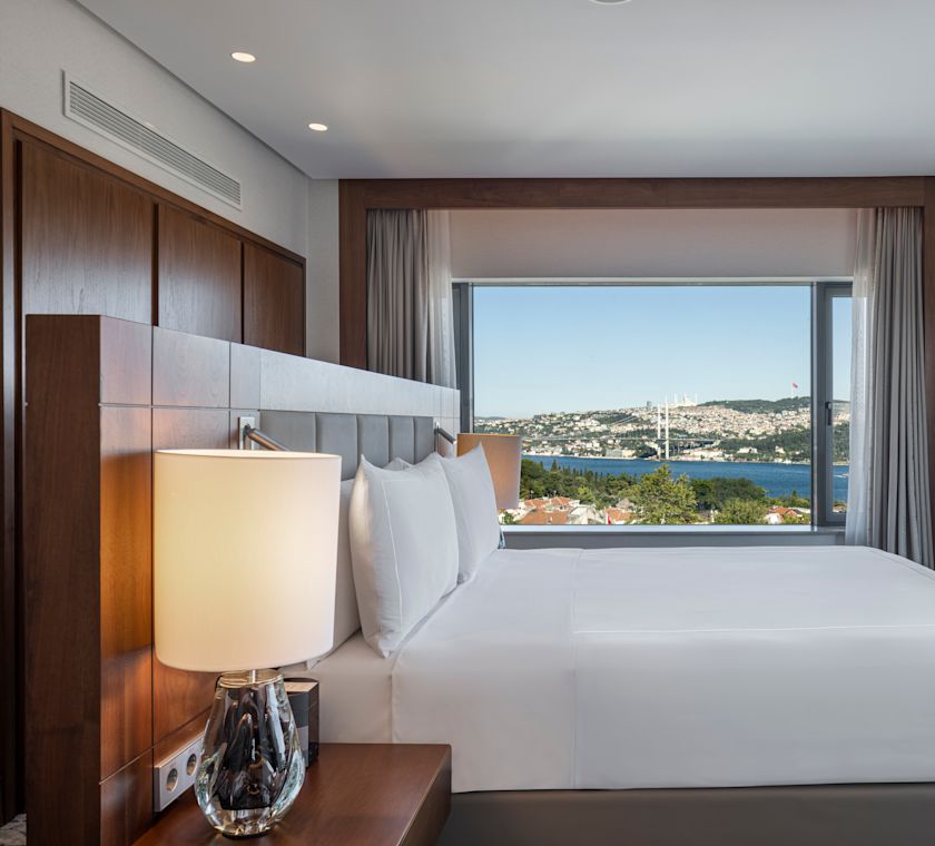 Bed in room with TV and lamp