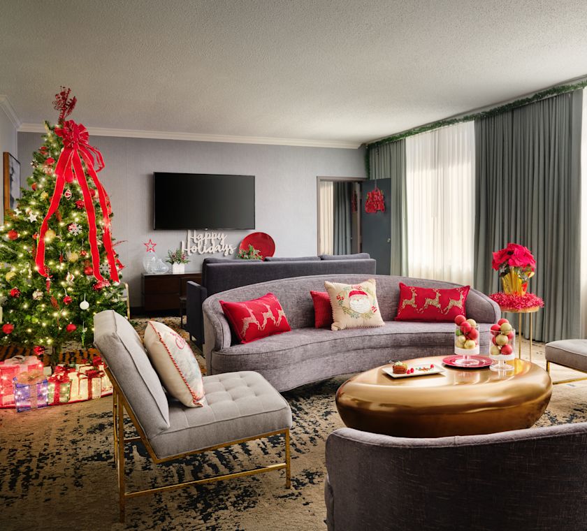 Lounge area in guest room with festive decorations including Christmas tree