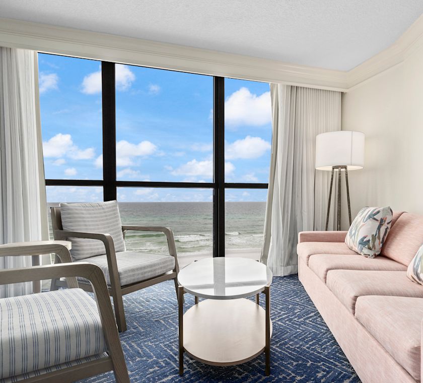 Guestroom lounge area with sofa and chairs