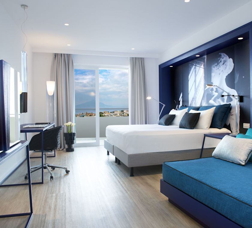 Guestroom with Bed, Sofa, Work Desk and Outside View and Patio