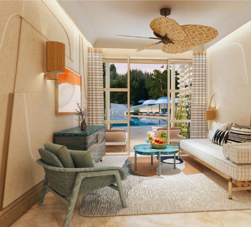 Innenansicht der Cabana am Swimmingpool mit Sitzbereich, Schreibtisch und durch die Tür sichtbarem Swimmingpool